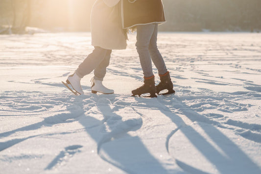 Couple ice skating on a frozen lake at sunset – not all hobbies in winter have to happen indoors
