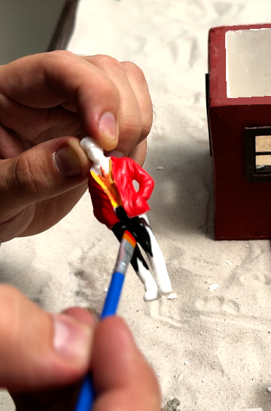 DIY mini boy figure being hand-painted – customizable accessory for miniature house kits