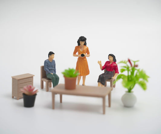 mini people - family figurines in a living room setting with furniture and plants