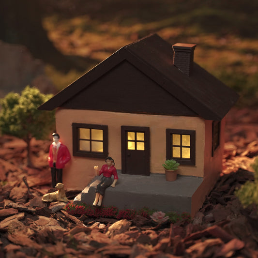 Miniature concrete house model with warm lights